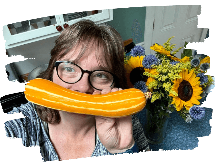Denise Beins, CEO, smiling with a yellow squash