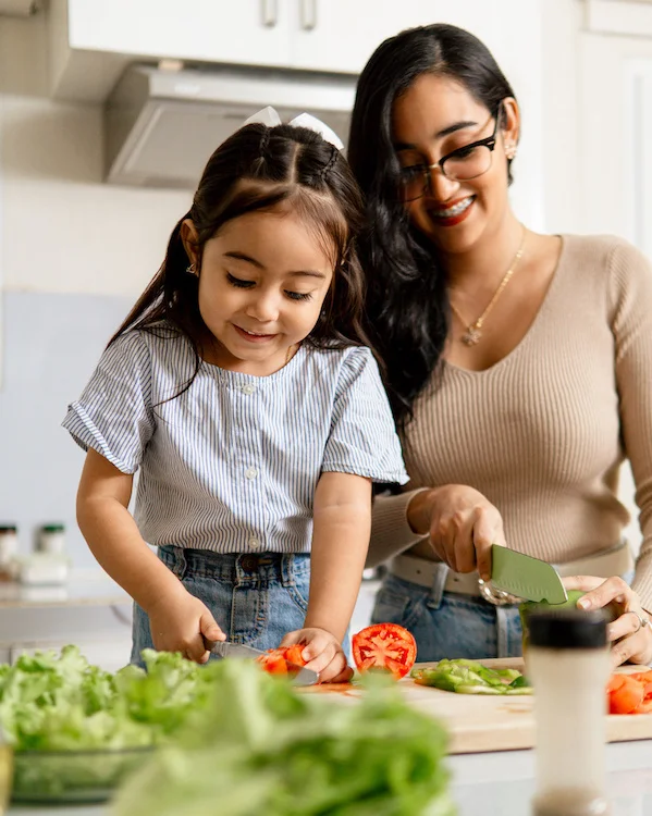 Mother and Daughter chopping vegetables together